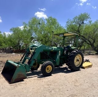 Tractor with front loader and mower serviced on site