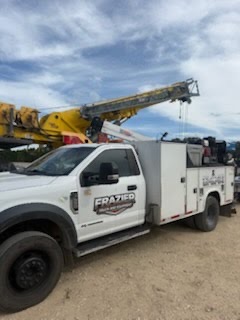 Frazier service truck on a job alongside a mobile crane