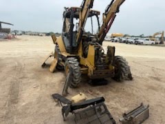 Backhoe loader stripped down for repair on site